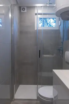 a bathroom with a shower with a toilet and a sink at Apartman Srna in Banja Luka