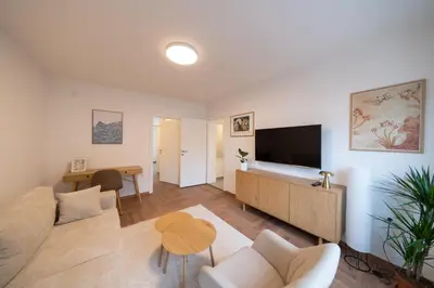 a living room with a couch and a tv and a table at Apartman Srna in Banja Luka