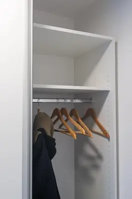a closet with wooden hangers on a shelf at Apartman Srna in Banja Luka