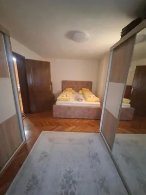 a bedroom with a bed with yellow pillows at Apartman - TAHRIC in Bihać