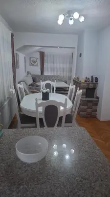 a kitchen and dining room with a table and chairs at Apartman - TAHRIC in Bihać
