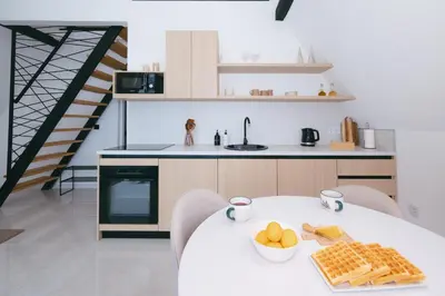 a kitchen with a table with a bowl of fruit on it at De Villa Bey in Kupres
