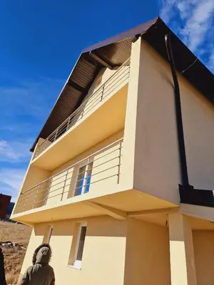 a building with a balcony on top of it at Vikendica Jadranka in Kupres