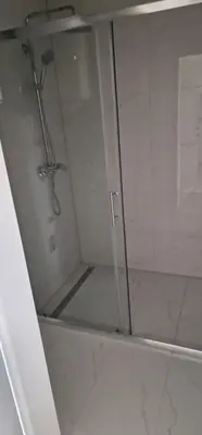 a shower with a glass door in a bathroom at Vikendica Jadranka in Kupres