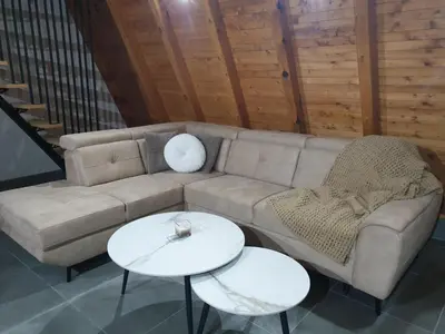 a living room with a couch and two tables at Kozara Resort