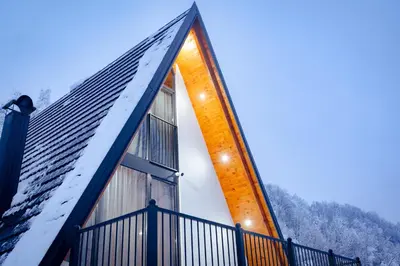 a house with snow on the roof at Kozara Resort