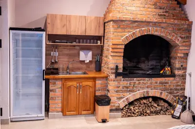 a brick oven in a kitchen with a counter and a sink at Kozara Resort