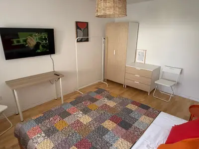 a bedroom with a bed and a tv on the wall at Welcome Apartment in Banja Luka