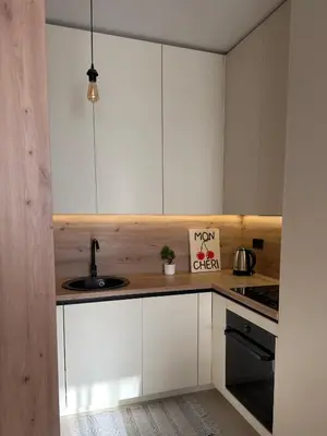 a kitchen with white cabinets and a sink at Apartman Green Park in Banja Luka
