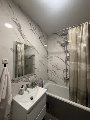a bathroom with a sink and a shower and a tub at Apartman Green Park in Banja Luka