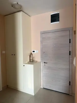 a large door in a room with a tv on the wall at Apartman Green Park in Banja Luka