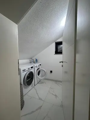 a laundry room with a washing machine and a washer at Villa Sky in Bosanska Krupa