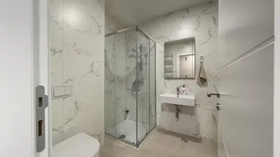 a bathroom with a shower and a toilet and a sink at Stela Stan Na Dan Banja Luka in Banja Luka