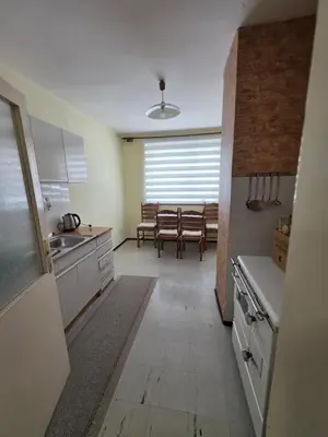 a kitchen with a table and a dining room at Apartman Daki in Vareš