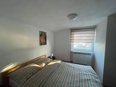 a bedroom with a bed and a window at Kuća za odmor Kuna in Kupres