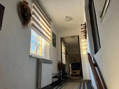 a hallway of a house with a window and a mirror at Kuća za odmor Kuna in Kupres