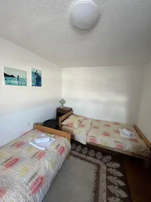 a room with two beds in a room at Kuća za odmor Kuna in Kupres