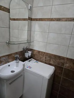 a small bathroom with a sink and a toilet at Apartman Wegele in Teslić