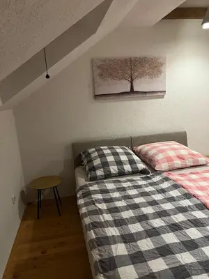 a bedroom with a bed and a tree picture on the wall at House in Kreševo - Mountain view - in Kreševo