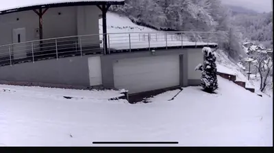 a building with a garage in the snow at House in Kreševo - Mountain view - in Kreševo