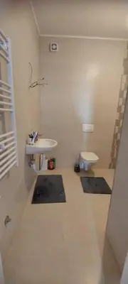 a bathroom with a sink and a toilet at Delta in Lukavac