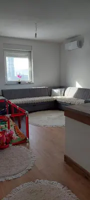 a living room with a couch and a table at Delta in Lukavac