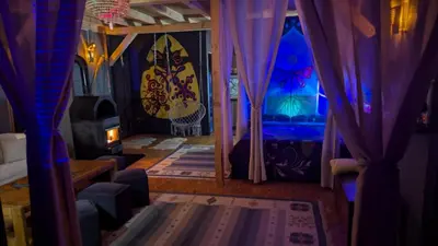 a room with purple and blue curtains and a bed at Neno Pyramid Wellness Retreat in Visoko