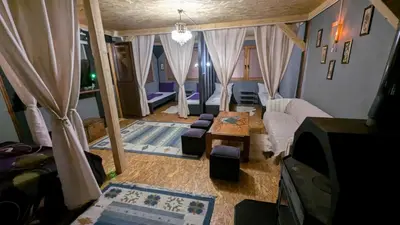a living room with a couch and a table at Neno Pyramid Wellness Retreat in Visoko