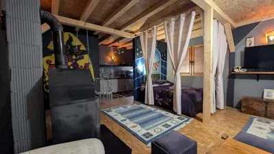 a room with a bedroom with a bed and a television at Neno Pyramid Wellness Retreat in Visoko
