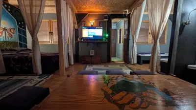 a room with a wooden table and a television at Neno Pyramid Wellness Retreat in Visoko