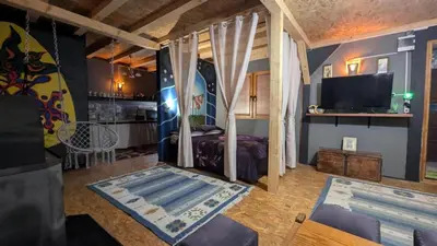 a living room with a bed and a tv at Neno Pyramid Wellness Retreat in Visoko