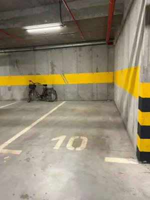 a bike is parked in a parking garage at Apartman Silencio 2 in Banja Luka