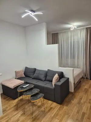 a living room with a couch and a bed at Apartman Silencio 2 in Banja Luka