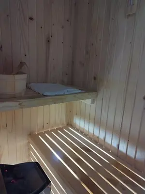 a sauna with a wooden paneled wall and a shelf at Drina in Pale