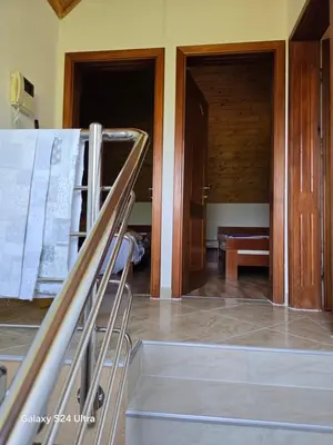 a room with a staircase and a room with two doors at Vikendica raj u lohovu in Bihać