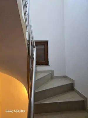 a staircase in a house with a window at Vikendica raj u lohovu in Bihać