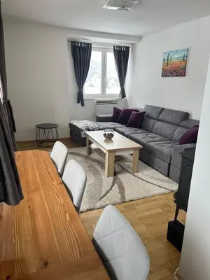 a living room with a couch and a table at Apartman Zimski Kutak in Kupres