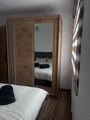 a bedroom with a mirror and a bed in it at Holiday House M&M Kupres in Kupres