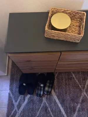 a table with a basket and shoes under it at Holiday House M&M Kupres in Kupres