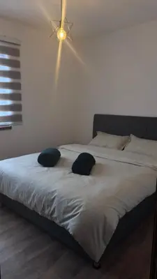 a bedroom with a bed with two pillows on it at Holiday House M&M Kupres in Kupres