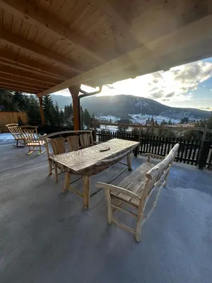 a wooden table and chairs sitting on a patio at Apartment Vlasic in Šišava