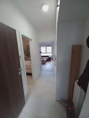 an empty room with a hallway with a door at Apartman Symbol in Tuzla
