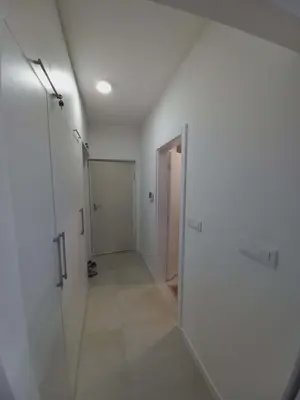 an empty hallway with a door to a bathroom at Apartman Symbol in Tuzla