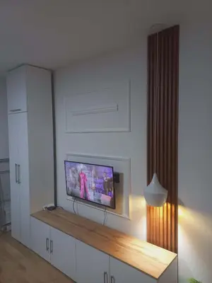 a living room with a flat screen tv on a wall at Apartman Symbol in Tuzla