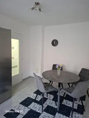 a table and chairs in a living room with at Avenue in Bosanska Krupa