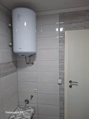 a bathroom with a shower with a toilet and a tank at Avenue in Bosanska Krupa