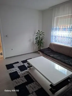 a living room with a couch and a table at Avenue in Bosanska Krupa