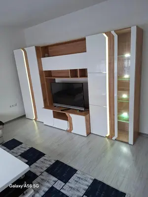 a living room with a tv and a wall with a closet at Avenue in Bosanska Krupa