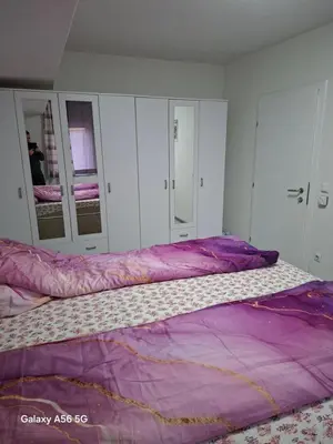 a bedroom with a large bed with purple sheets at Avenue in Bosanska Krupa