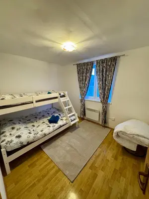 a bedroom with two bunk beds and a window at Apartman Zimski Kutak in Kupres